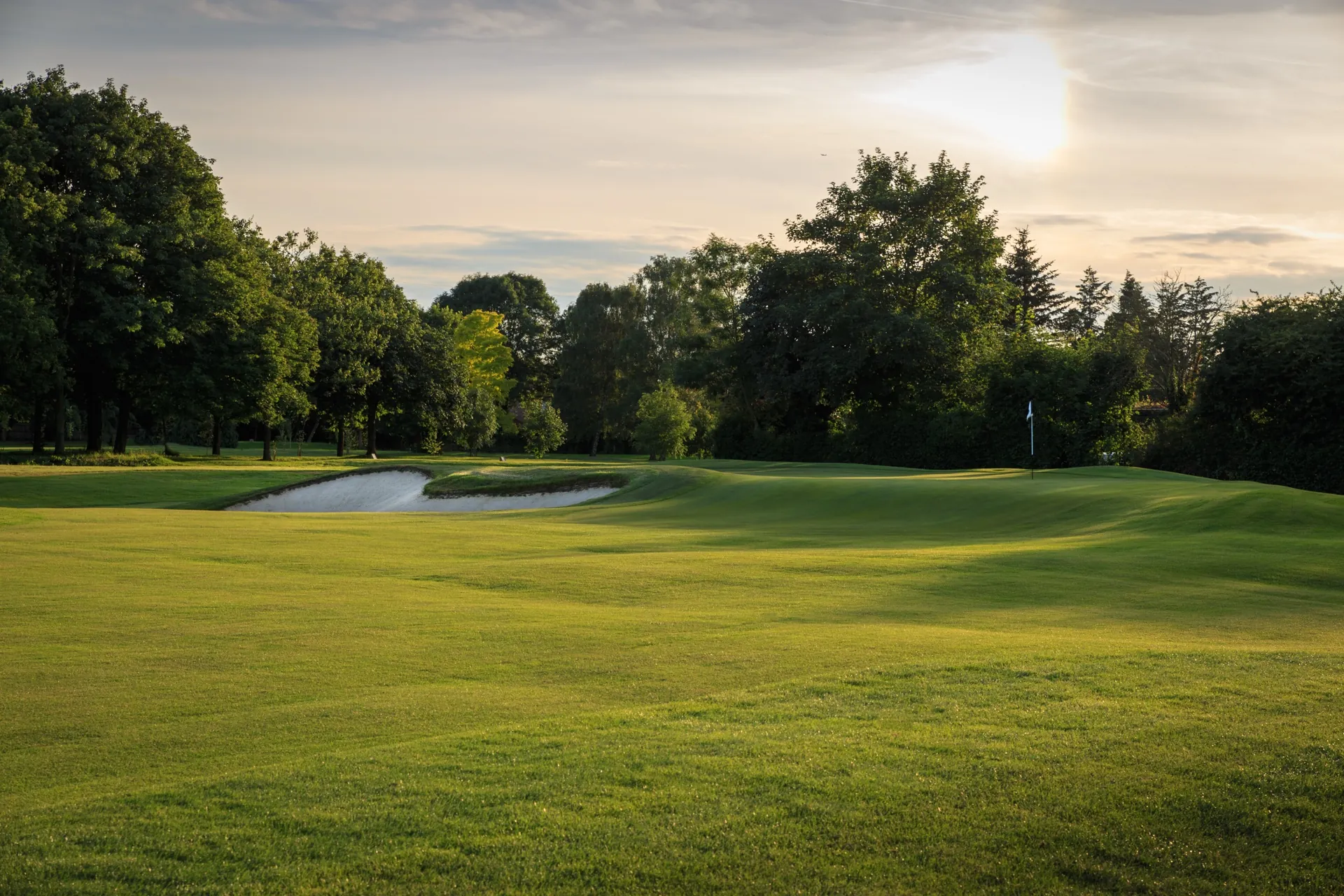 Ashford Manor Golf Club — 18th green at sunset